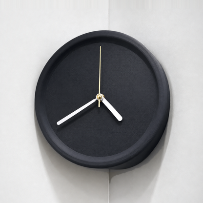 Black corner wall clock hung in an inside wall corner, plain dial with white hands