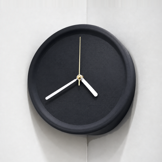 Black corner wall clock hung in an inside wall corner, plain dial with white hands