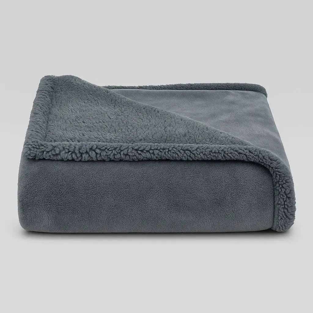Gray waterproof blanket folded on a light gray backdrop, smooth plush outside with the curly sherpa side turned back over the top
