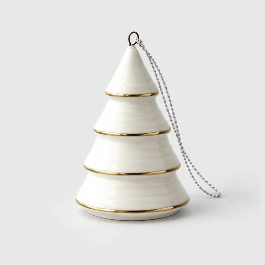 White ceramic Christmas tree ornament in the Cone style, a stepped cone with thin gold lines around each tier, standing on a light gray background with its silver hanging cord