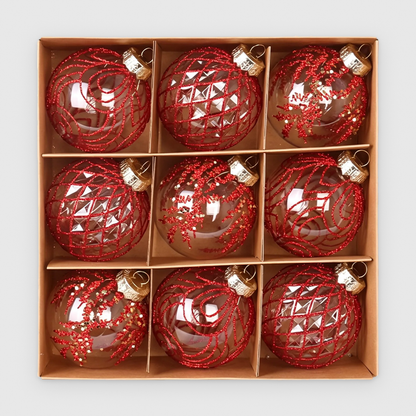 Box of 9 clear Christmas baubles with red glitter swirl, lattice and frond designs and gold caps