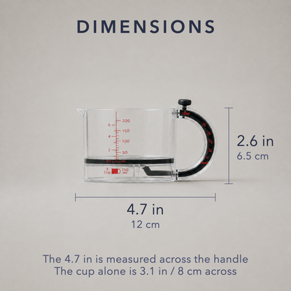 Dimension card for the clear adjustable measuring cup on plain grey: 4.7 in / 12 cm across including the handle, 2.6 in / 6.5 cm tall, with a note that the cup alone is 3.1 in / 8 cm across