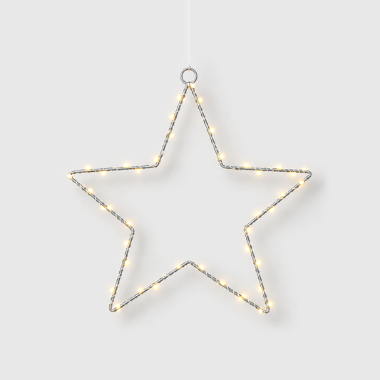 LED star light hanging from its top ring, its warm white beads lit, on a light gray background