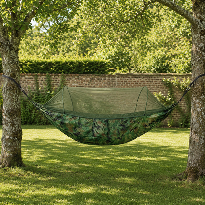 Camouflage Green ultralight camping hammock with bug net in a walled garden