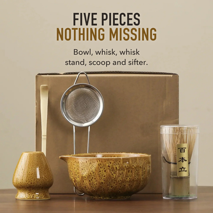 Yellow matcha set in front of a plain wall with the words five pieces, nothing missing: bowl, whisk, whisk stand, scoop and sifter