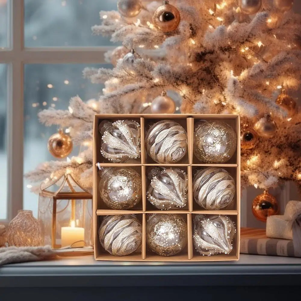 Champagne glitter baubles in their box in front of a frosted Christmas tree by a window