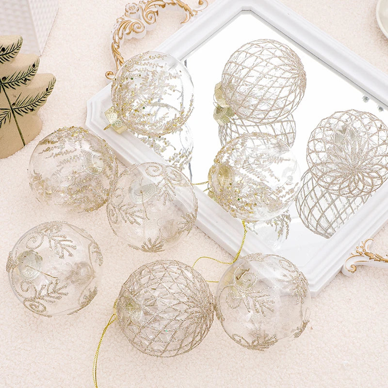 Clear baubles with champagne glitter patterns resting on a mirror tray with gold hanging thread