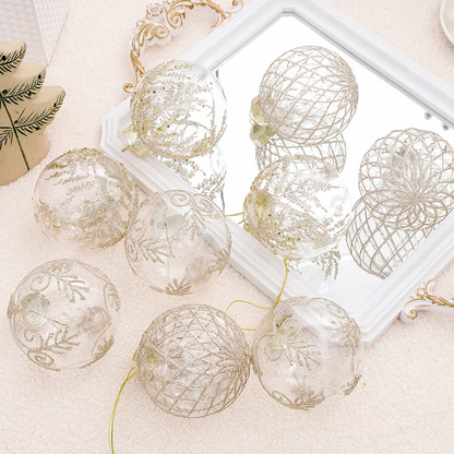 Clear baubles with champagne glitter patterns resting on a mirror tray with gold hanging thread