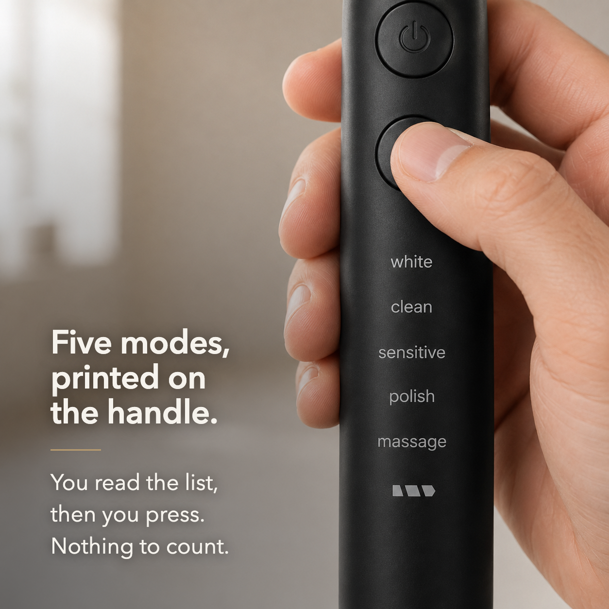 Electric toothbrush held in one hand with the five mode names printed down the handle