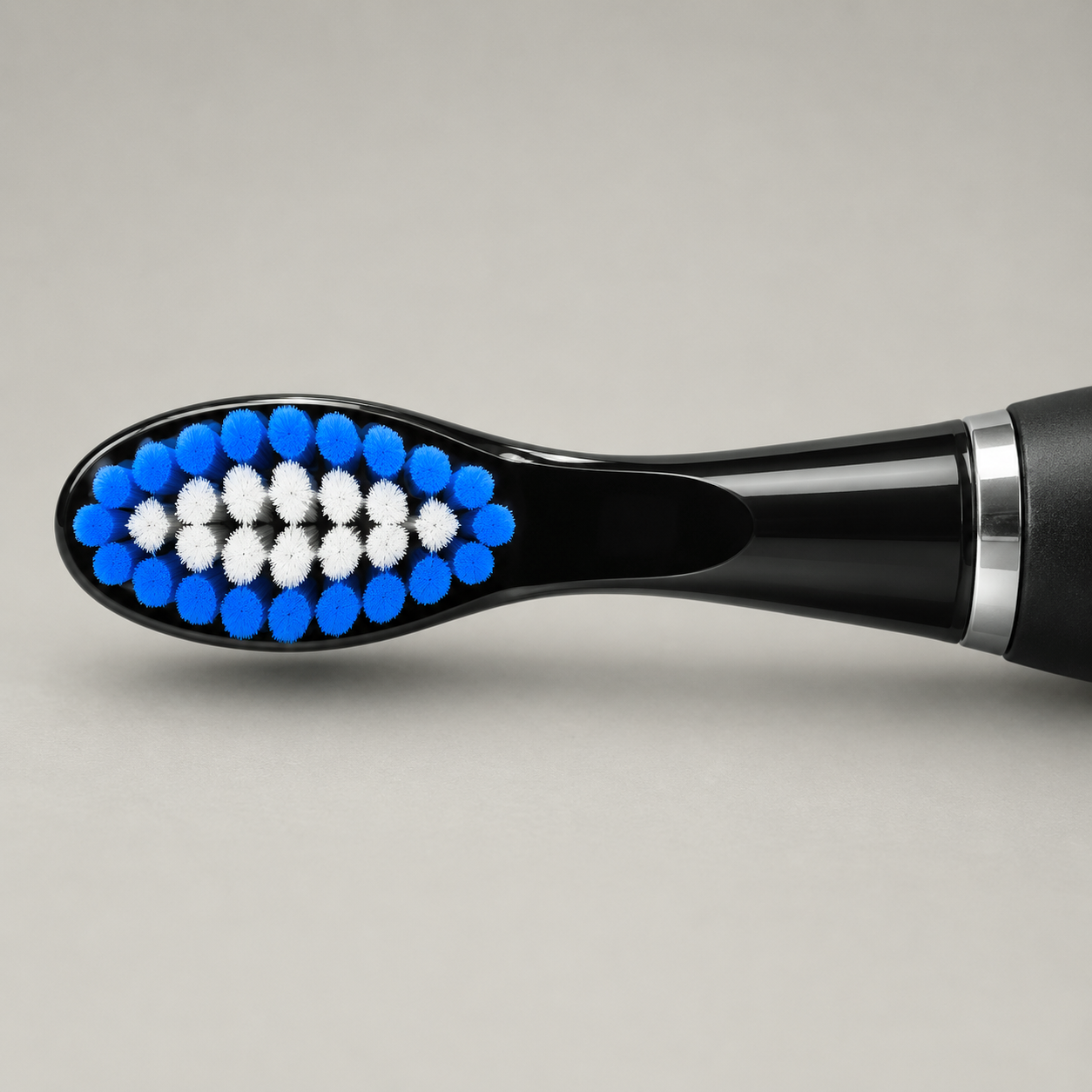 Close up of the brush head, blue outer bristles around a white centre