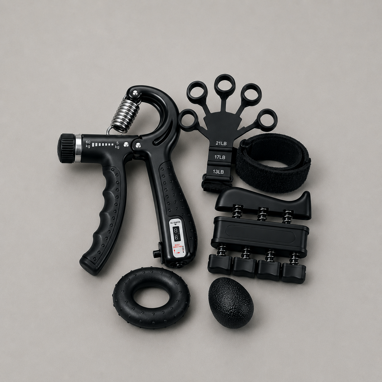All five pieces laid out on grey: hand gripper, finger extensor with wrist strap, finger exerciser, forearm ring and grip ball