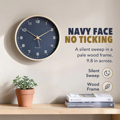 Text image: Navy face, no ticking, a silent sweep in a pale wood frame 9.8 inches across, with icons for silent sweep and wood frame