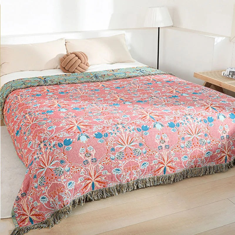 Coral pink reverse side of the bedspread spread over a bed