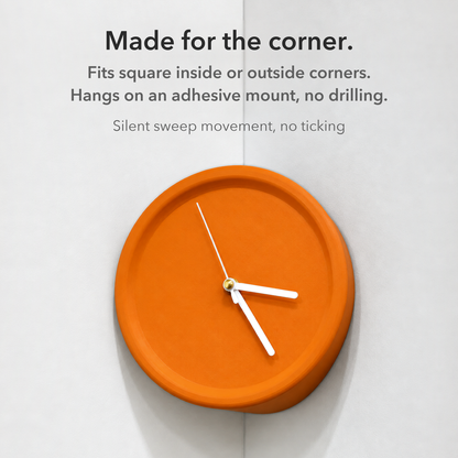 Orange corner wall clock in a wall corner with the words Made for the corner