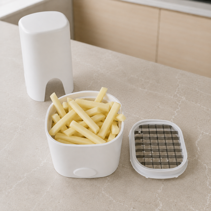 The catch base full of freshly cut raw fries with the blade grid insert lifted out and lying beside it
