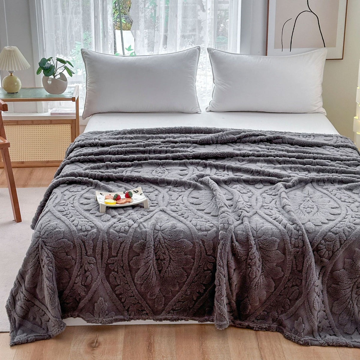 Gray damask fleece blanket over a bed with a breakfast tray on top