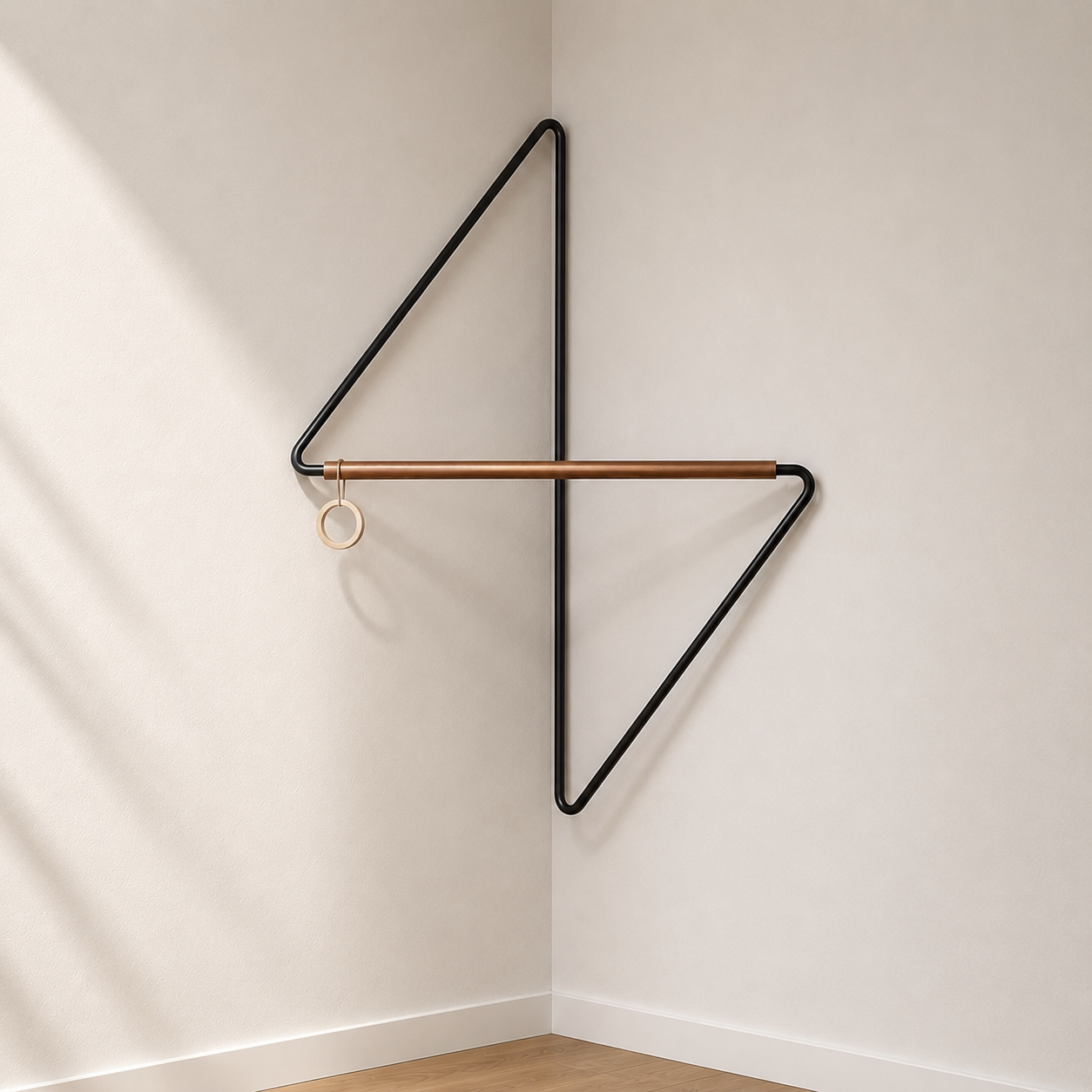 Black metal corner coat rack sitting empty in a hallway corner, showing the open pinwheel frame with one arm above the crossbar and one below.