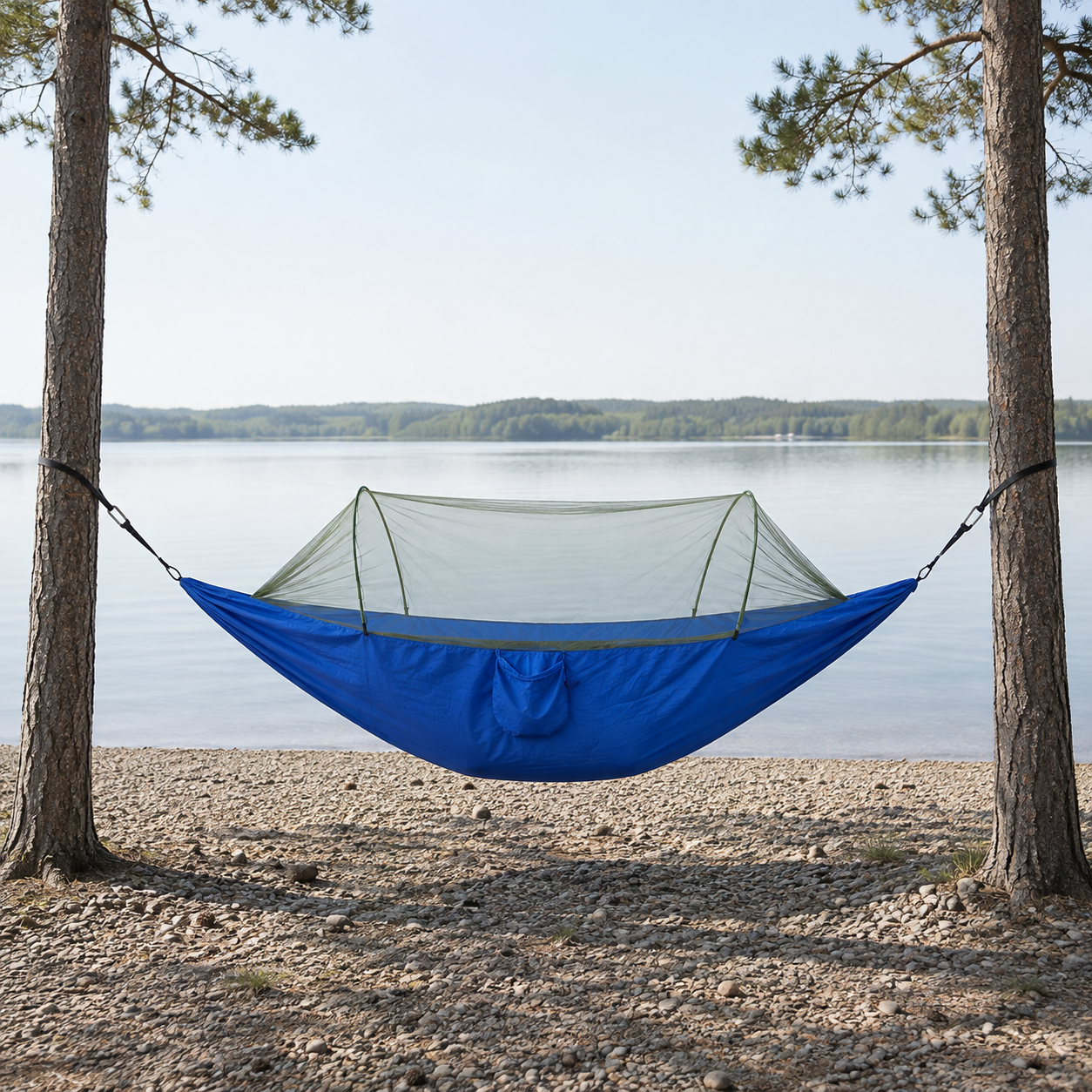 Sky Blue ultralight camping hammock with bug net on a lakeshore