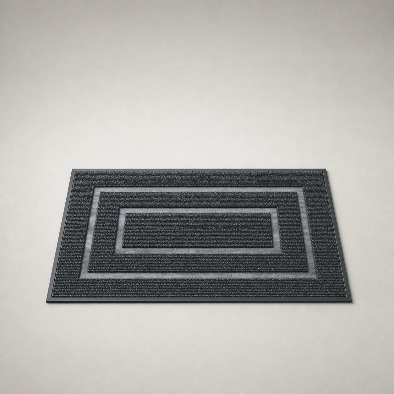 Black door mat on a plain gray studio background, seen from a low three-quarter angle.