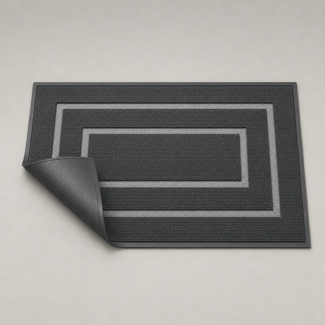 Black door mat with one corner folded back to show the plain black rubber underside.