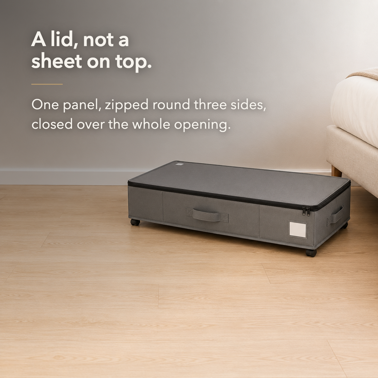 Gray under bed storage box with its single-panel zippered lid closed over the whole opening.
