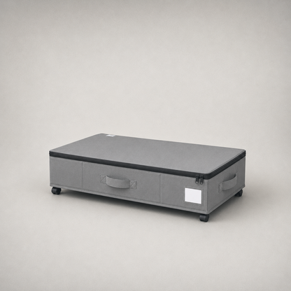Gray under bed storage box, three-quarter studio view on a plain gray background, zippered lid closed and a castor at each corner.