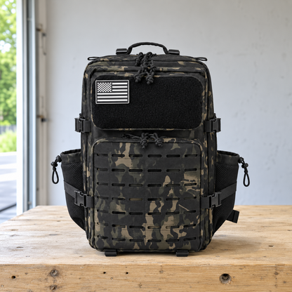 Black camouflage laser cut MOLLE tactical backpack on a garage workbench