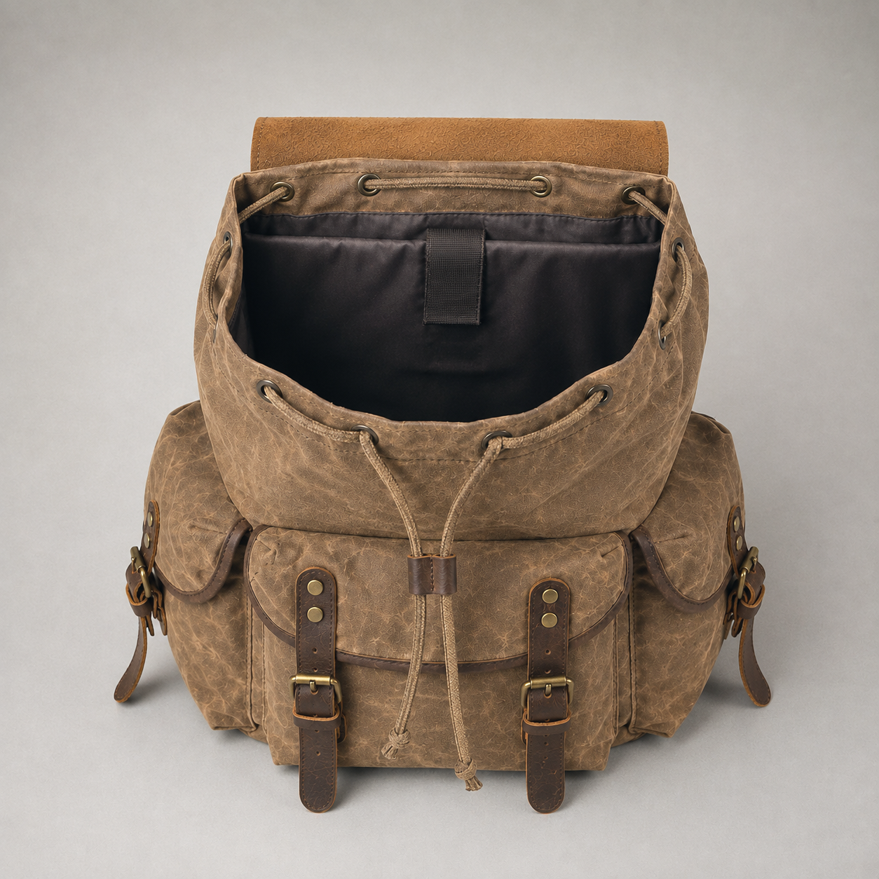 The rucksack with its drawstring mouth open, showing the lining and the padded laptop sleeve