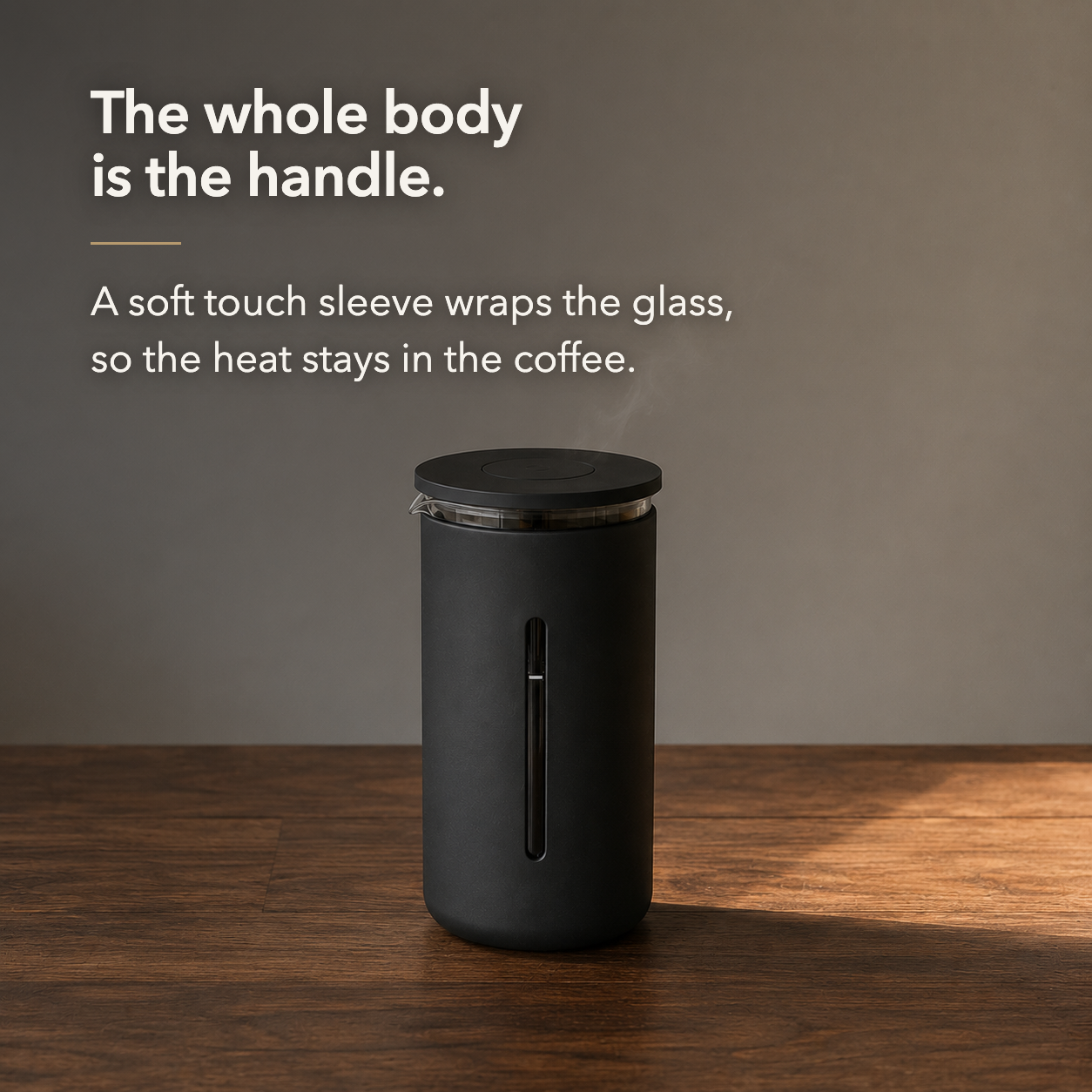 Black French press standing on a bare walnut table with steam rising from its lip.