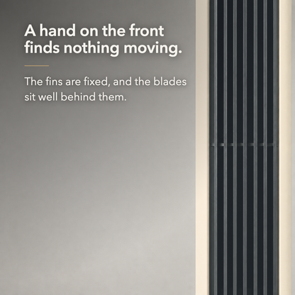 Close view of the black louvred outlet column with text reading A hand on the front finds nothing moving.
