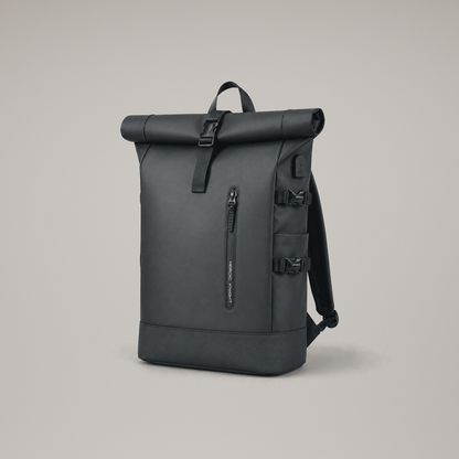 Studio front three quarter view of the Black roll top backpack on a warm grey backdrop