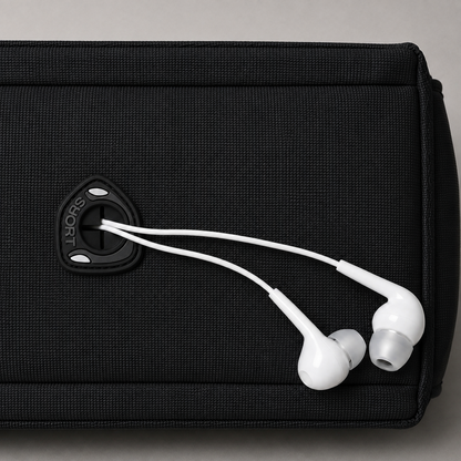 Close up of the rubber cable pass through on the side panel, with a pair of wired earphones led out through its slit