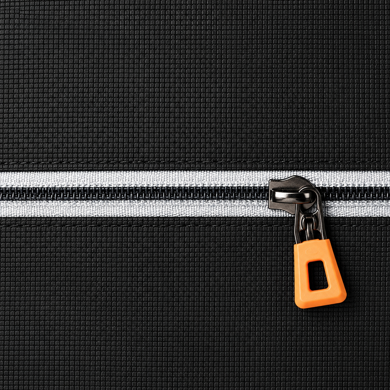 Close up of the single front zip, its light grey tape and its orange pull tab