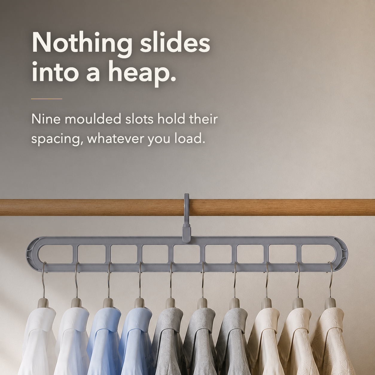Text over a closet photograph reading Nothing slides into a heap., with nine moulded slots holding hangers at even spacing
