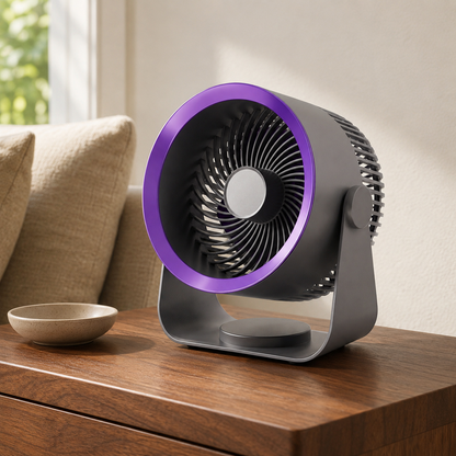 Grey air circulator fan with a violet ring around its face, standing on a walnut side table in a living room in daylight