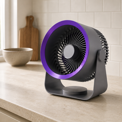 Grey air circulator fan on a pale stone kitchen countertop with a white tiled splashback behind it