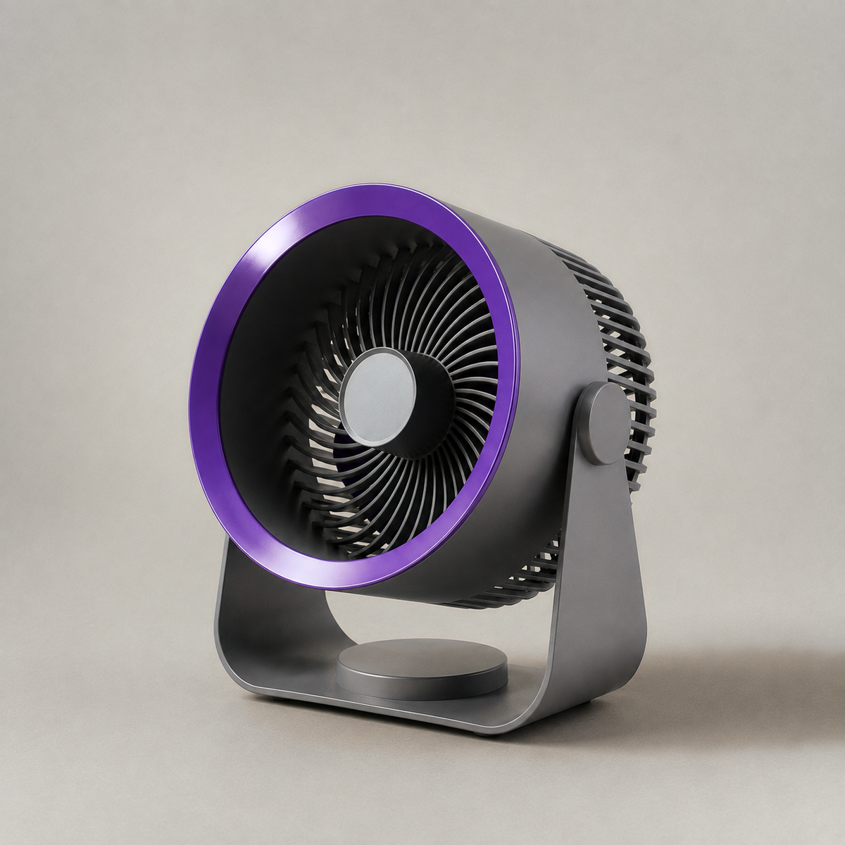 Grey air circulator fan on a plain grey background, three-quarter view showing the violet ring, the spiral guard and the U-shaped cradle stand