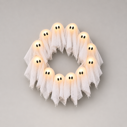 Ghost wreath lit warm white, photographed square on against a plain grey studio background
