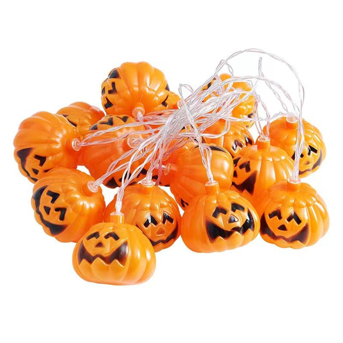 Unlit pumpkin string lights on a white background showing the orange shells and clear wire