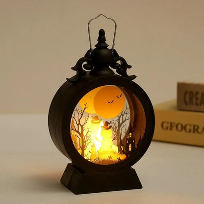Halloween lantern with the pumpkin scene lit, standing on a table beside books
