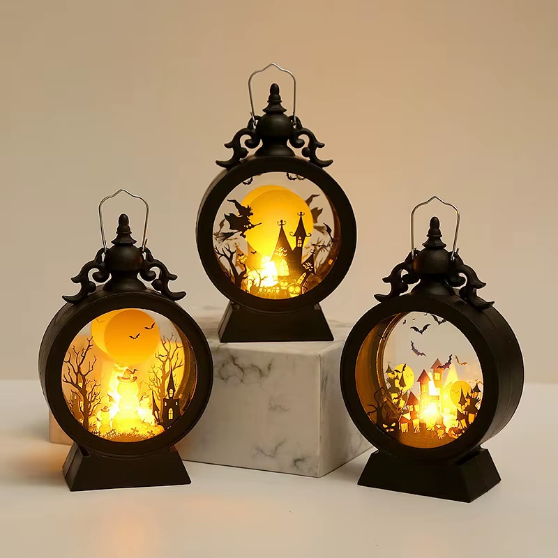 Three Halloween lanterns lit together at different heights, one turned to show the depth of the drum