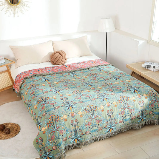 Botanical bedspread over a bed in a bright white bedroom, seen from the foot corner