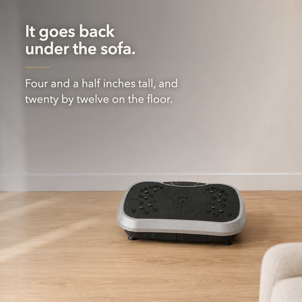 Vibration plate on oak floorboards below the words It goes back under the sofa