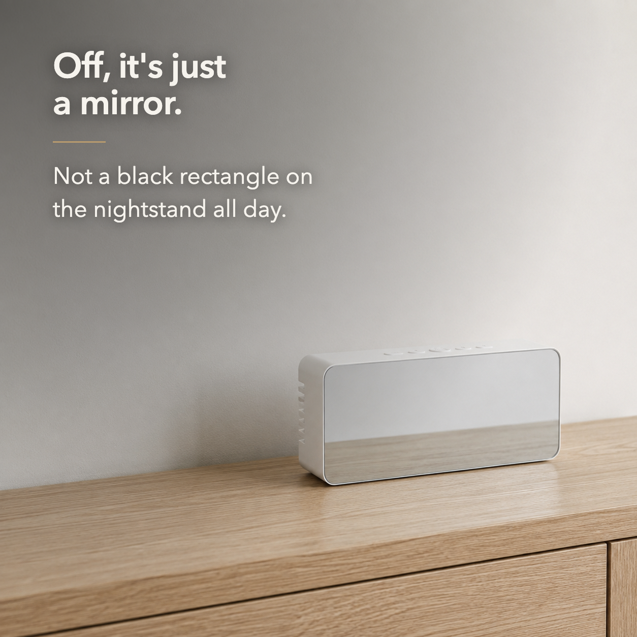The mirror alarm clock with its display off, the front reading as a plain mirror rather than a screen