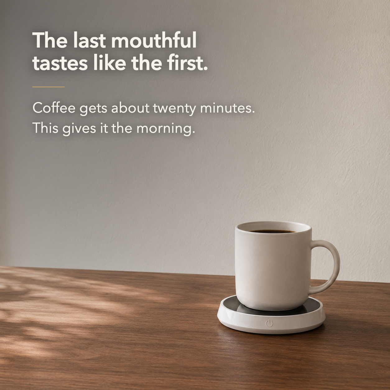 Mug of coffee on the warmer on a desk, with the words the last mouthful tastes like the first