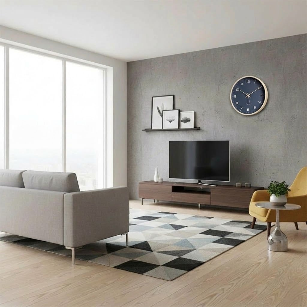 Navy blue wall clock hung on a gray concrete wall above a walnut TV unit in a bright living room