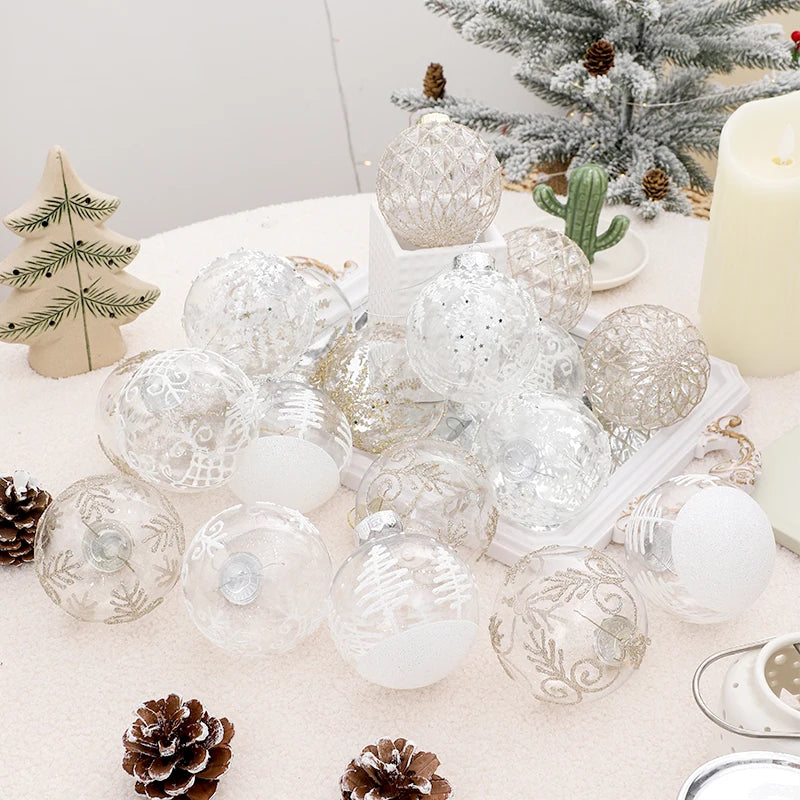 White and champagne glitter clear baubles heaped on a snowy table beside a flocked tree and a candle