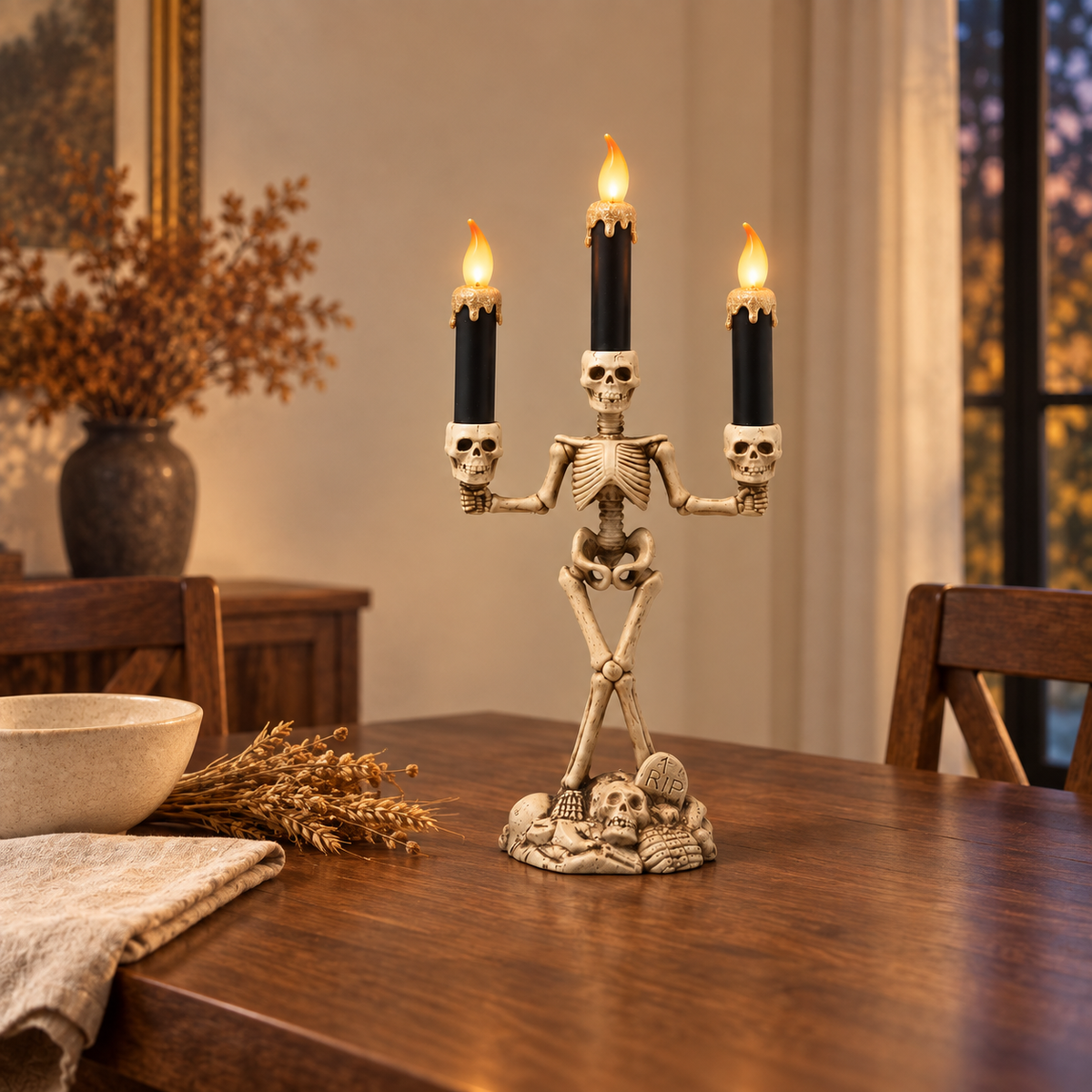 Skeleton candle holder with gold candles lit on a walnut dining table