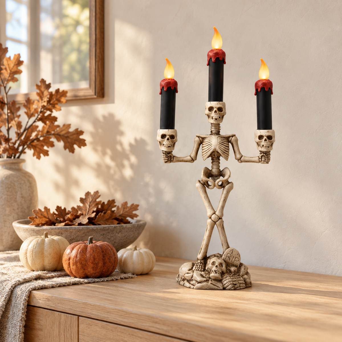 Skeleton candle holder with red candles lit on an oak sideboard in a bright autumn-styled room