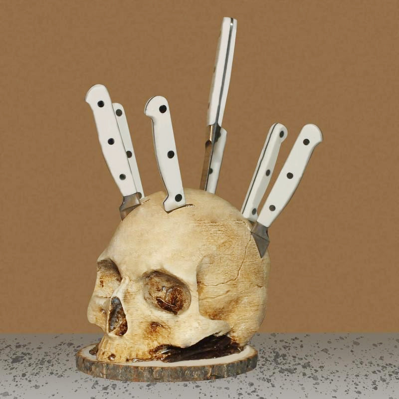 Full front view of the skull knife block on its round non-slip base, six knives standing in the crown